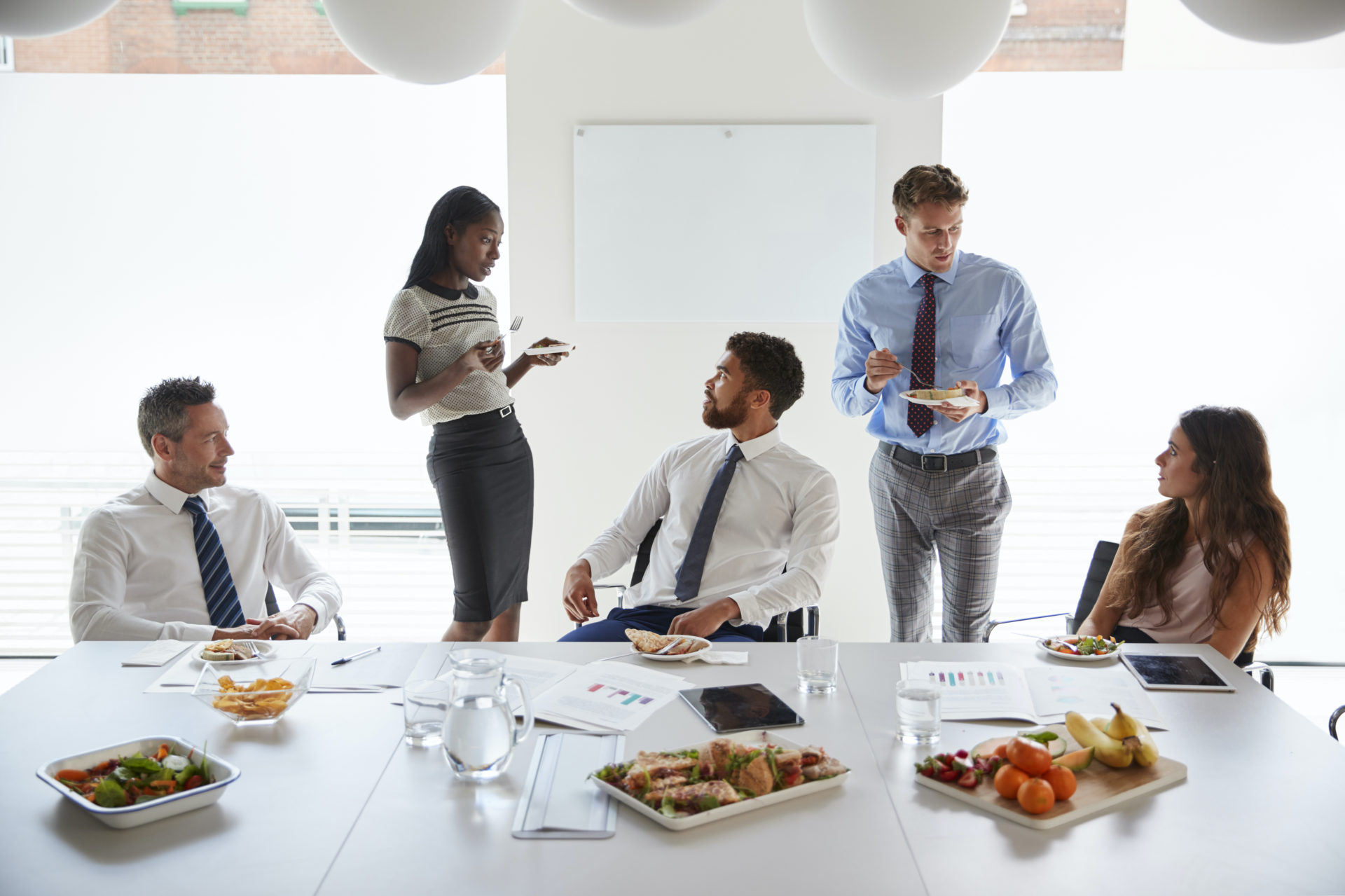 corporate workers enjoying catering delivery food.