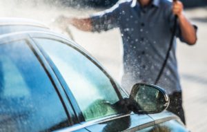 man washing car